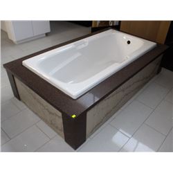 KOHLER HYTEC BATHTUB WITH STONE COVERED SURROUND