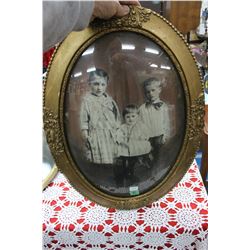 Portrait of Three Children in a Wooden Oval Convex Glass Frame