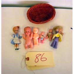 A Basket of Tiny Plastic 20th Century Dolls