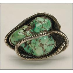 Navajo silver ring, bezel set with a large turquoise nugget, encircled and overlain with a serp...