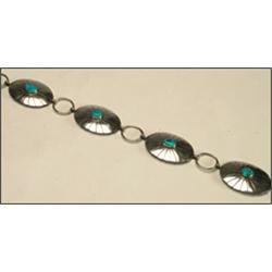 Navajo sterling silver belt, composed of 12 connected conchas each formed as a scallop-edged ov...