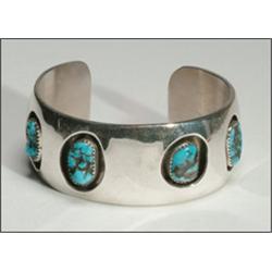 Navajo sterling silver open bangle, set with 4 irregular turquoise nuggets in shadow-boxed serr...