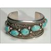 Image 1 : Navajo sterling silver open bangle, set with 7 oval turquoise cabochons in serrated bezels on a...