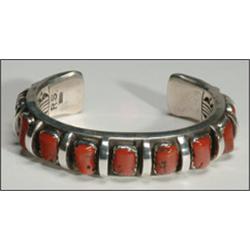 Navajo sterling silver open bangle, formed of a thick ingot band set with a row of 9 irregular...