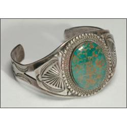 2 Navajo silver open bangles, each formed as a flared flat band and set with oval turquoise cab...