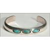 Image 2 : 2 Navajo silver open bangles, the first formed as an ingot band set with 3 oval turquoise caboc...