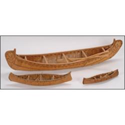 A Woodland birchbark and wood frame model canoe with floral decoration, together with two smaller...