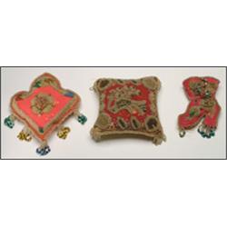 Two Woodland pin cushions, each decorated with clear and coloured floral beadwork, together with...
