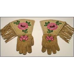 A pair of northern Woodland hide gauntlets, decorated with floral embroidery, bead work and a bea...