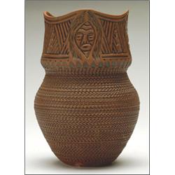 TALKING EARTH,, GUARDIAN SPIRIT,, A Six Nations ceramic vase with all over carved decoration...