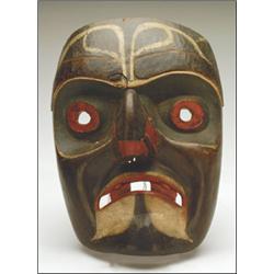 A Kwakiutl carved and painted wood bird mask, with pierced mouth and attached beak, 11" - 27.9 cm...