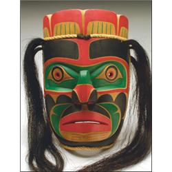 RANDY STIGLITZ, A Northwest Coast carved and painted wood portrait mask, with rope and hair att...