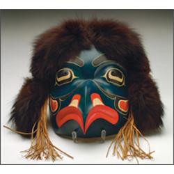 TSOONA STELLA, A Northwest Coast Haida carved and painted wood Eagle mask, with fox fur and ced...