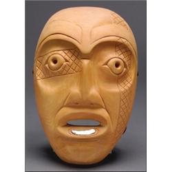 A Northwest Coast wood mask, decorated with incising and an inset abalone lip labret, signed Rock...