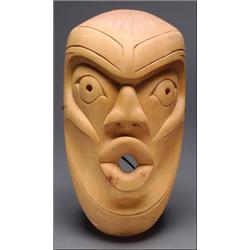 ROCKY JONES (1949 - ), A Northwest Coast carved wood face mask, with incised decoration, signed...