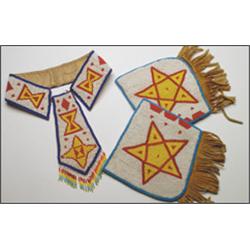 A pair of Plains hide and cloth cuffs with matching collar / tie, decorated with beaded geometric...