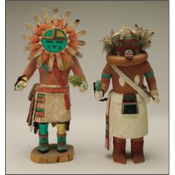 TWO HOPI POLYCHROME WOOD KACHINA DOLLS, one helmeted figure clutching a carved rattle in the righ...