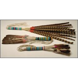 A Southwest ceremonial wand, the hide handle with embroidered decoration and feathers, together w...
