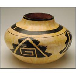 AN ACOMA SEED JAR, painted all over in a pale earth tone, with a black stylized motif, 10" - 25.4...