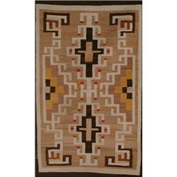 NAVAJO RUG, mid 20th Century, two latch-hook medallions in white, brown and red on a tan field...