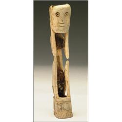 Bone Figure of a Seated Man, with knees drawn up, hands to head, with drilled eyes and line for...