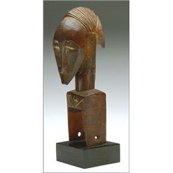 Baule Heddle Pulley, the characteristic body surmounted by a head with ovoid face and pointed c...