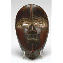 Dan Mother Mask, the ovoid face with sunken eyes encircled with traces of white pigment, the ey...