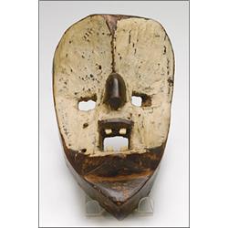 Dan Mask, the roughly worked concave ovoid face with square eyes and mouth painted white, the m...