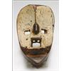 Image 1 : Dan Mask, the roughly worked concave ovoid face with square eyes and mouth painted white, the m...