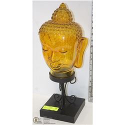 AMBER GLASS BUDDHA HEAD ON STAND.