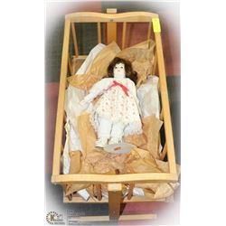 WOOD CRADLE WITH PORCELAIN DOLL.
