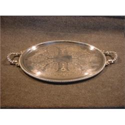 Un plateau ovale en métal argenté gravé.  A chased oval plated silver tray. $150/250...