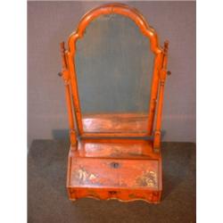 Un miroir à raser de la fin du 18e Siècle en bois relaqué rouge à décor de scènes orientales doré...