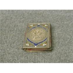 Un carnet de bal en argent émaillé orné de trois amours en relief, poinçons français d'exportatio...