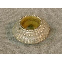 Un bracelet indien en argent transformé en coupelle.  An Indian silver bracelet made into a vesse...