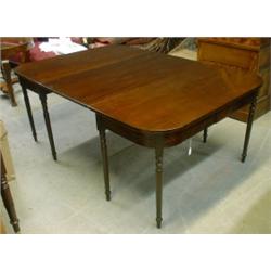 Une table de salle à manger d'époque Guillaume IV en acajou, vers 1835, composée de deux consoles...