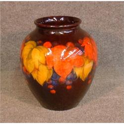 Un vase en poterie de Moorcroft à décor de pampres sur fond noir, (restauré)....