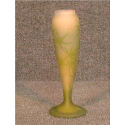 Un vase de Gallé décoré en camée de feuillage vert sur un fond rose, signé....