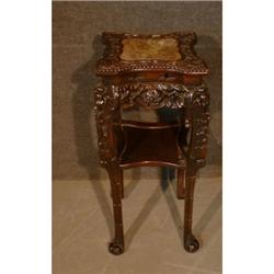 Un guéridon chinois, le plateau chantourné serti d'une plaque de marbre rouge sur une base et des...