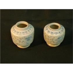 Une paire de petites jarres cylindriques décorées de doubles pivoines et de branches sous une fri...