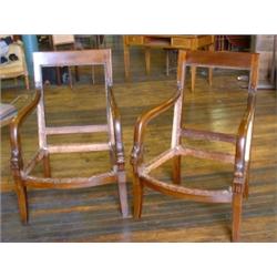 Une paire de bergères de style Restauration en acajou, vers 1850, les accoudoirs sculptés en form...