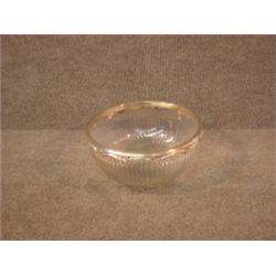 Un bol en cristal taillé à monture française chantournée en argent....