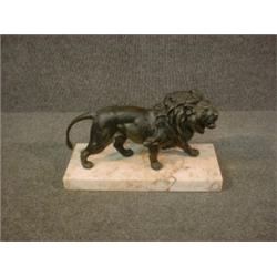 Un sujet en bronze patiné représentant un lion.  A patinated bronze figure of a lion. $400/600...