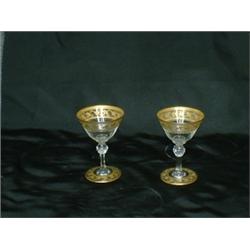 Un ensemble de 8 verres à porto en verre gravé à décor de rinceaux dorés....