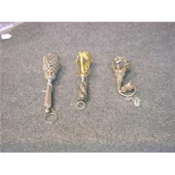 Un lot de trois porte-bouquets en métal argenté et doré....