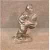 Image 1 : Une sculpture inuit en stéatite représentant un homme portant un sac, signé....