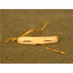 Une paire de lunettes inuit en os de baleine.  A pair of Inuit whalebone spectacles. $100/150...