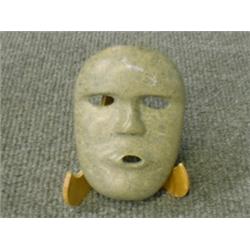 Un masque inuit en stéatite.  An Inuit stone carving of a mask. $80/120...