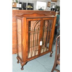 Antique black walnut two door curio cabinet with carved ball and claw feet and two glass shelves