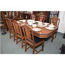 Walnut refractory style dining table with jack knife leaf and six dining chairs including one carver